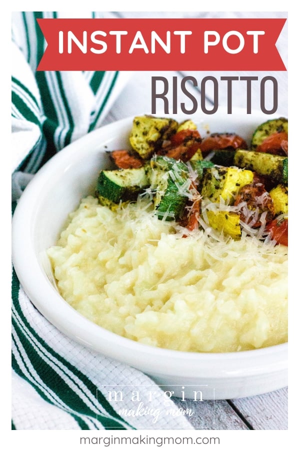 white bowl filled with parmesan risotto cooked in the Instant Pot, alongside roasted vegetables