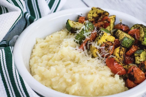 white bowl filled with instant pot parmesan risotto and roasted vegetables