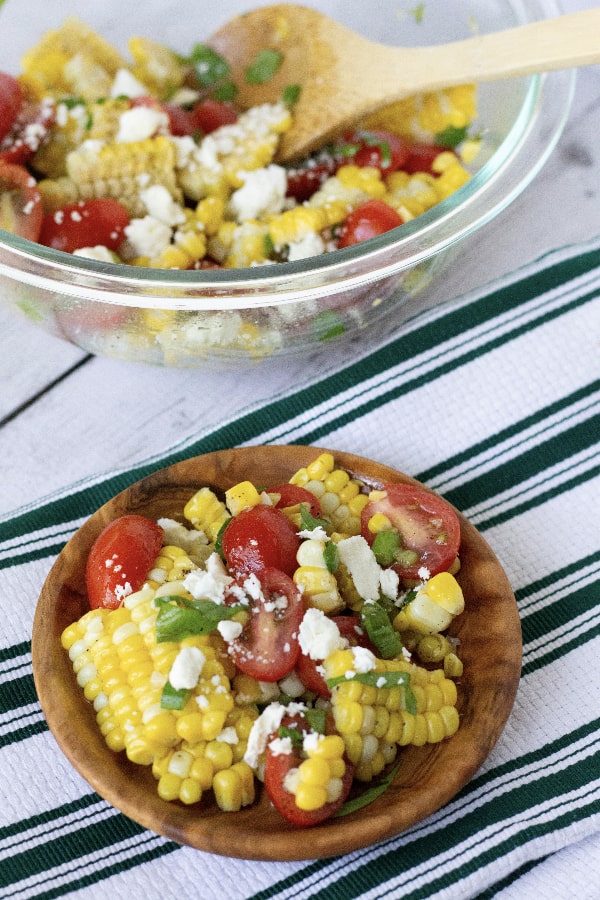 brown bowl filled with summer sweet corn and tomato salad