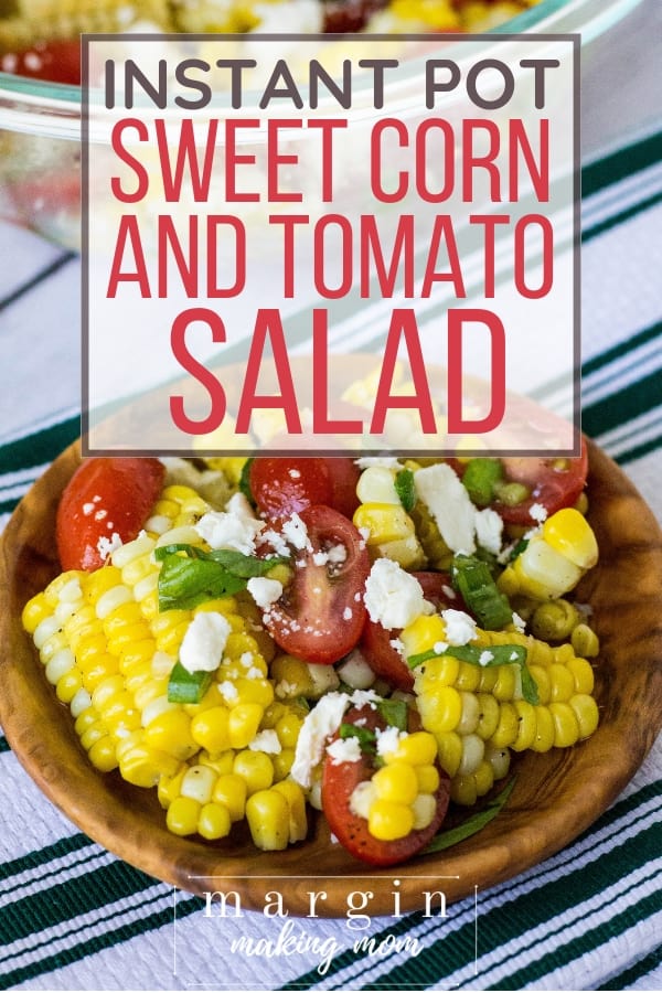 wooden bowl filled with summer corn and tomato salad, where the corn was cooked in the Instant Pot