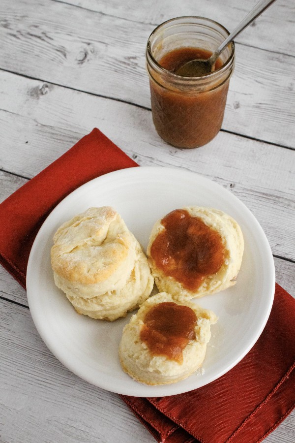 white plate with biscuits topped with apple butter cooked in the Instant Pot