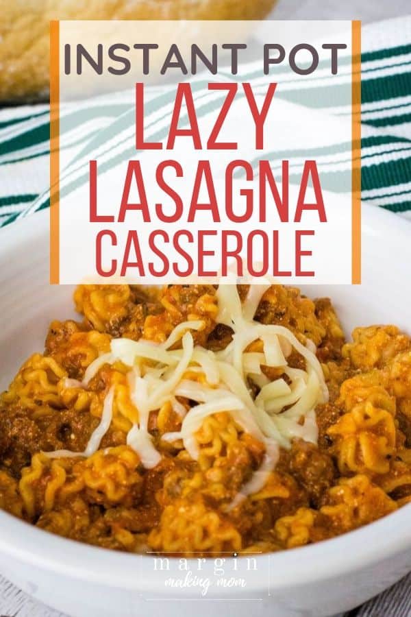 White bowl filled with Instant Pot lazy lasagna casserole and topped with shredded mozzarella cheese