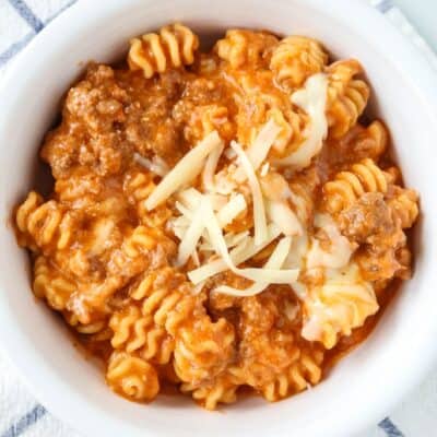 Instant Pot lazy lasagna casserole served in a white bowl, topped with cheese.