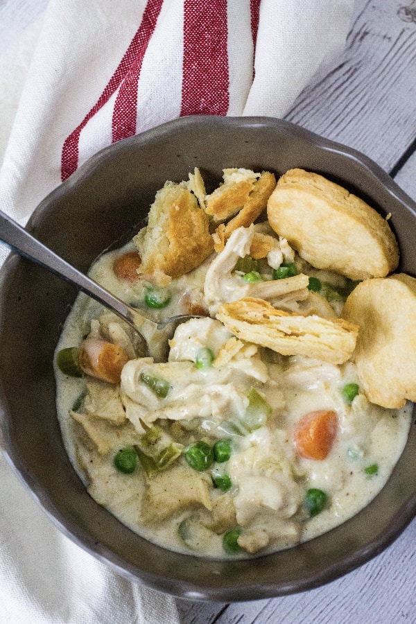 brown bowl filled with chicken pot pie filling cooked in the Instant Pot and served with pie crust