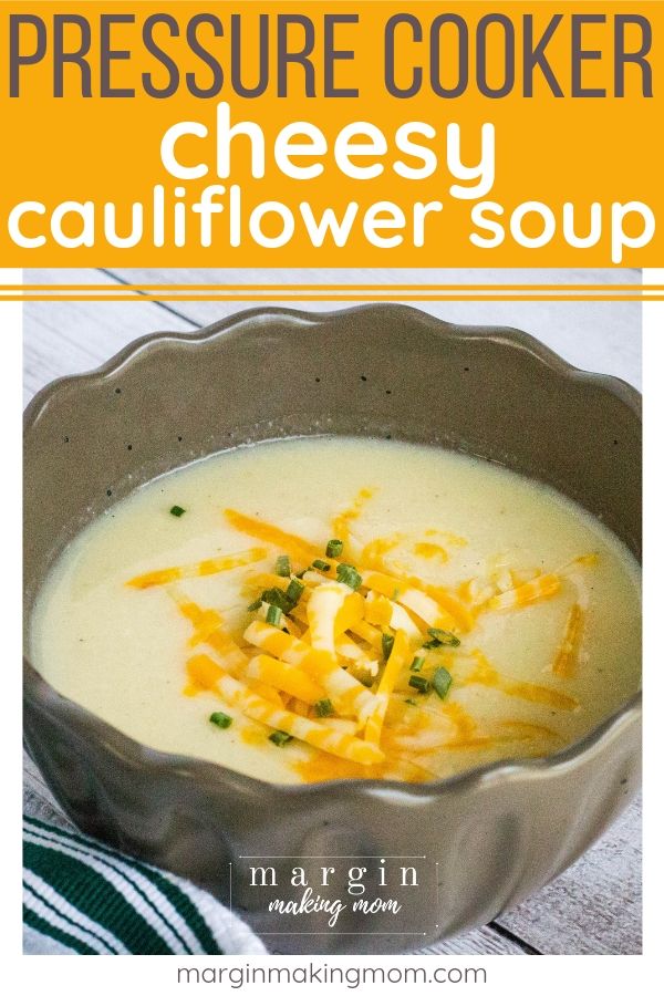 cauliflower soup that was cooked in the pressure cooker, served in a brown bowl and topped with snipped chives and shredded cheese