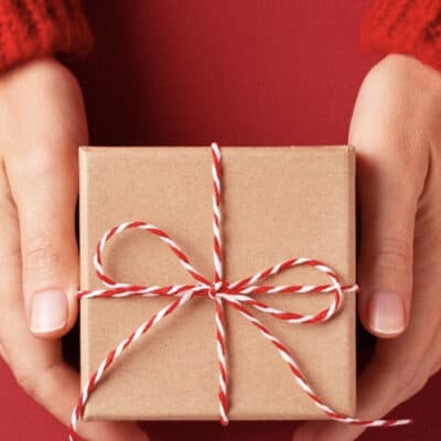 woman's hands holding a christmas gift
