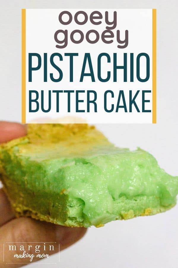 Pistachio ooey gooey butter cake square being held by a woman's hand