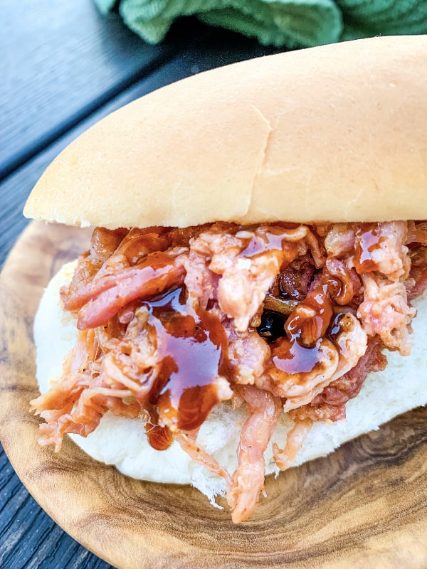 pulled pork sandwich drizzled with barbecue sauce