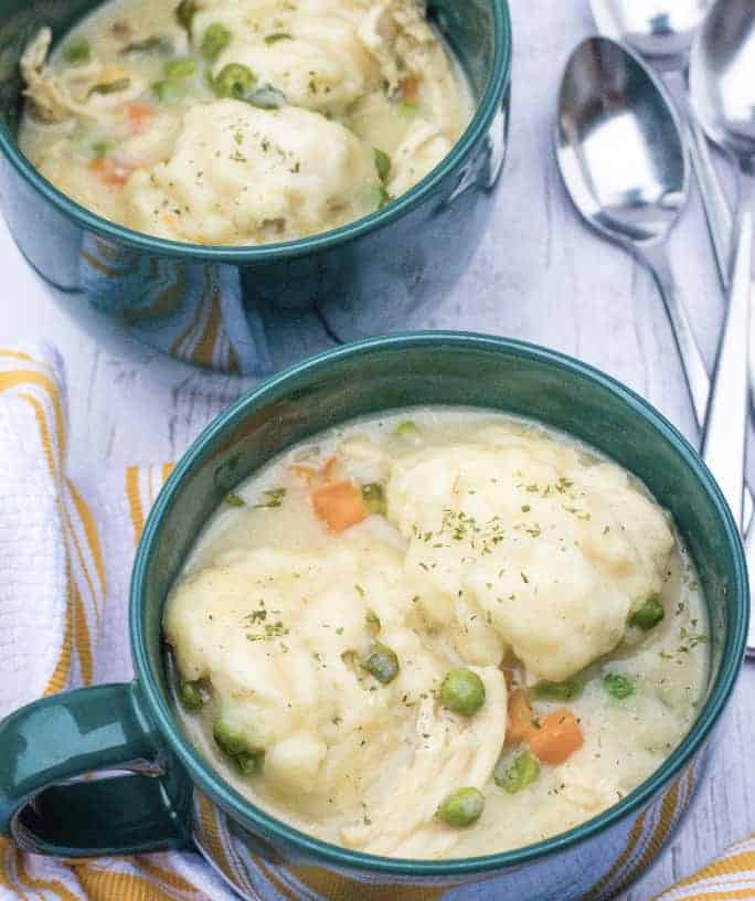 Easy chicken and Bisquick dumplings served in green soup mugs