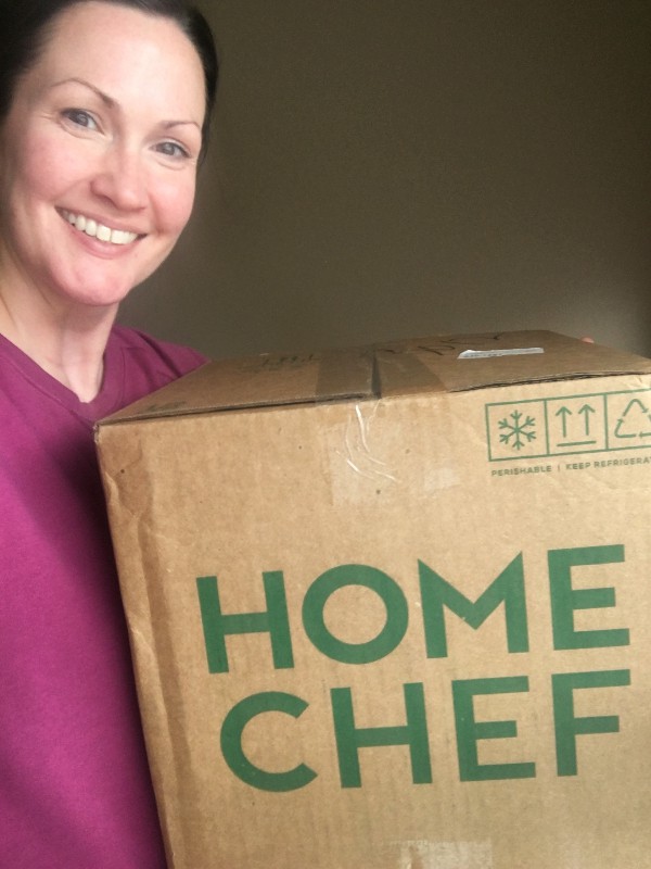 Author holding a Home Chef box