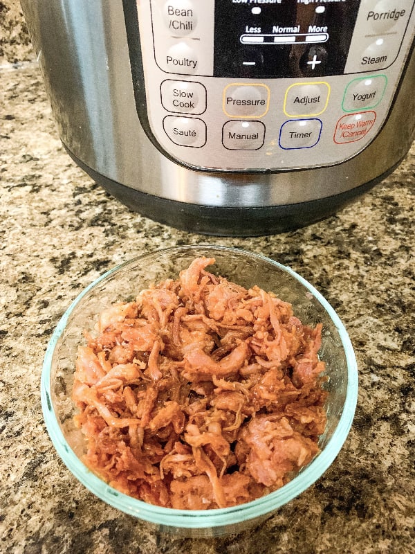 dish of barbecue pulled pork to be reheated in the Instant Pot pressure cooker