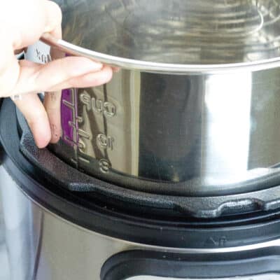 An insert pot being lifted from an Instant Pot