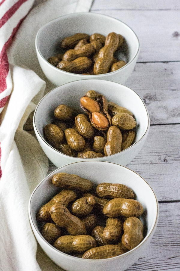 three small bowls filled with crockpot boiled peanuts