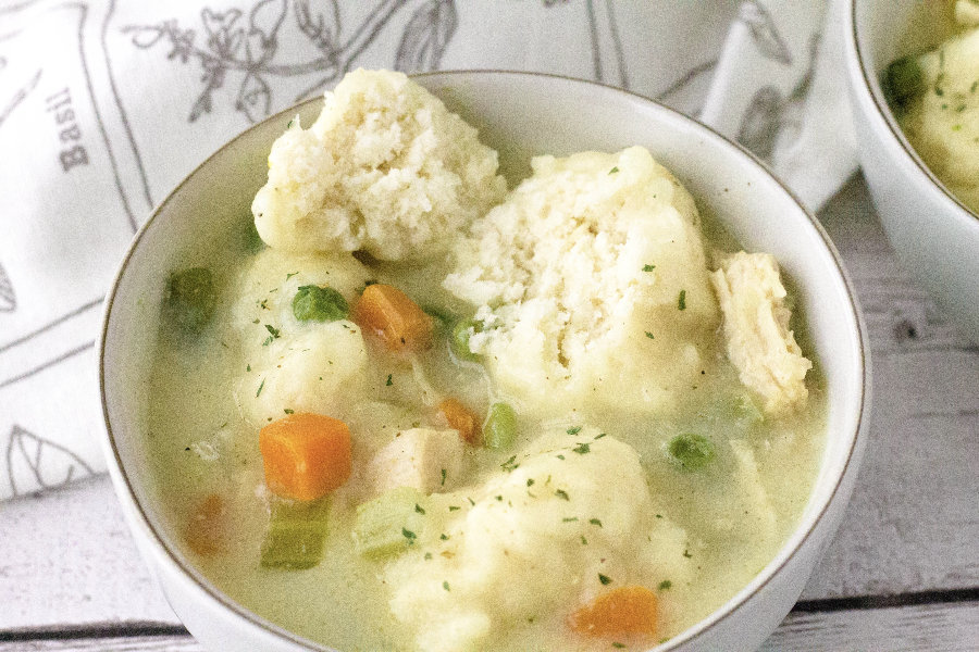 white bowl filled with chicken and dumplings made with Bisquick in the Instant Pot