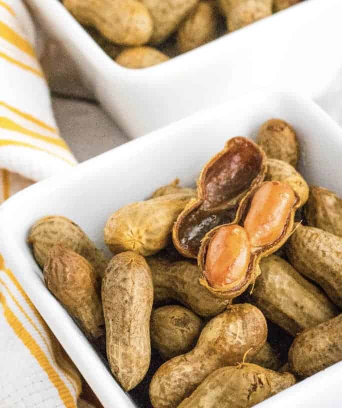white bowl filled with cajun boiled peanuts cooked in the Crockpot