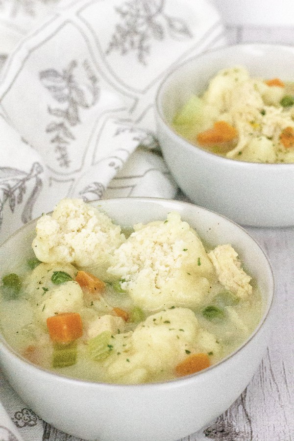 Two white bowls filled with Instant Pot chicken and dumplings made with Bisquick