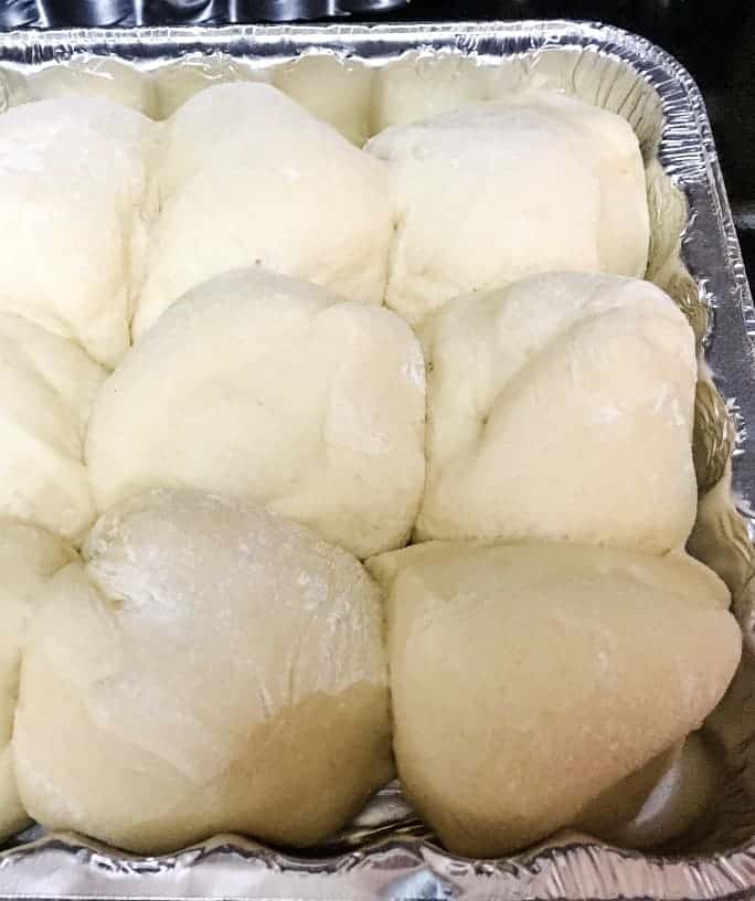 aluminum pan of unbaked dough for dinner rolls