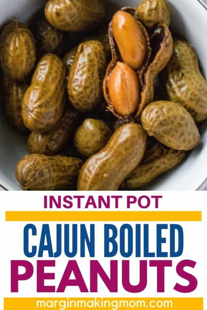 Cajun boiled peanuts, with one shell cracked open displaying two tender peanuts inside