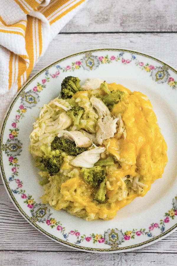 china plate with a serving of Instant Pot cheesy chicken broccoli and rice casserole.