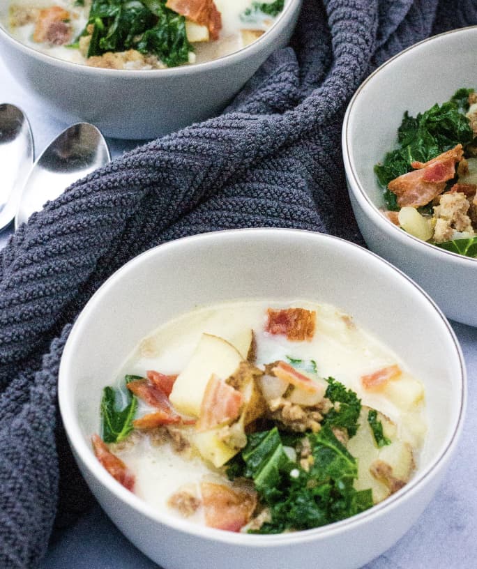three white bowls filled with a healthier version of zuppa toscana cooked in the Instant Pot