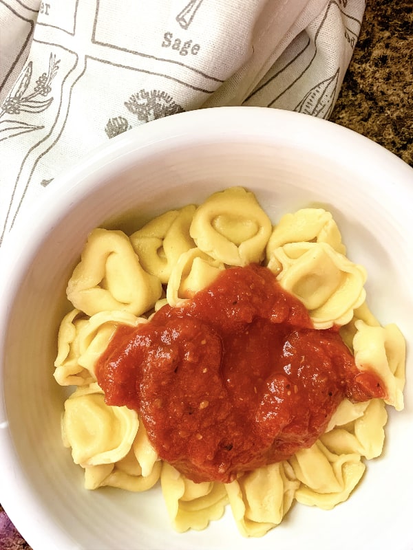 Instant Pot tortellini with marinara sauce in a white bowl