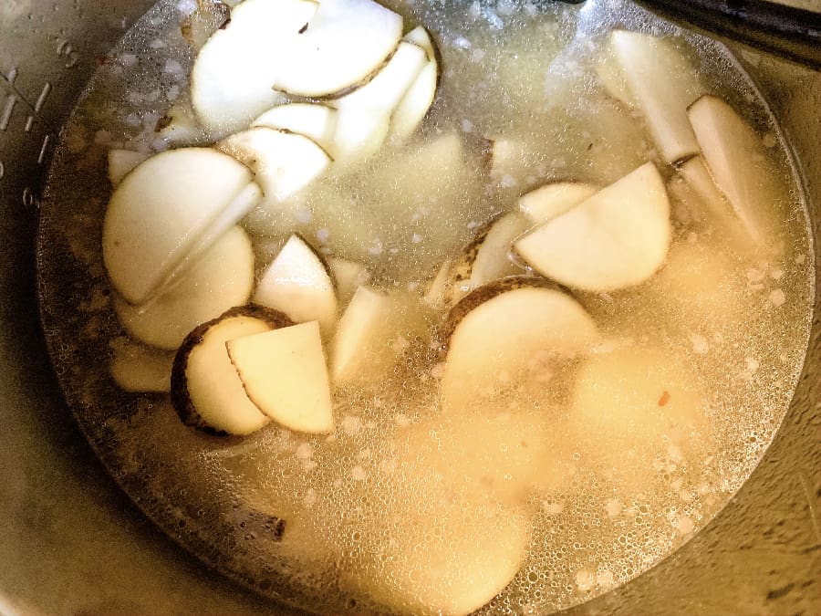 broth, potatoes, sausage, and other ingredients for making healthy zuppa toscana soup in the Instant Pot