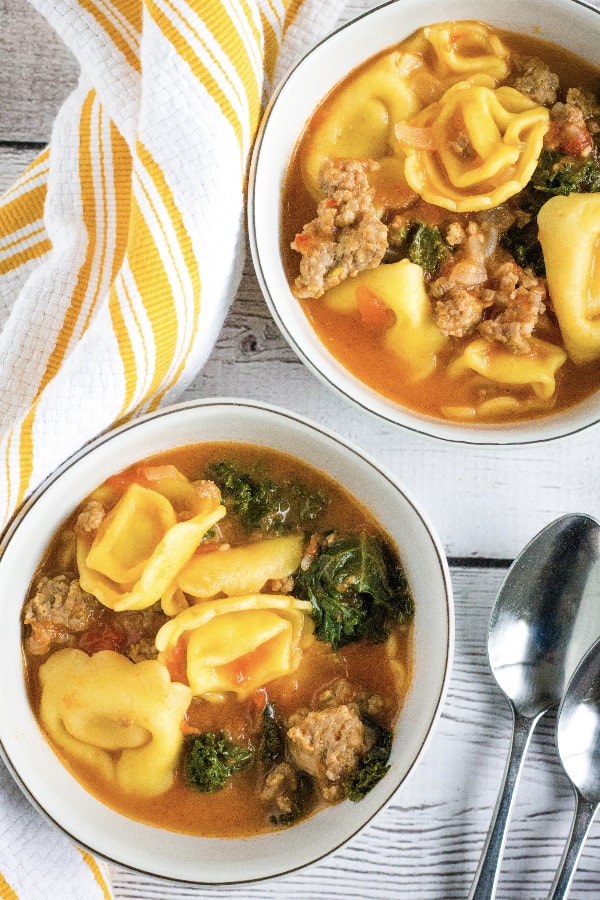 two white bowls filled with Instant Pot tortellini soup