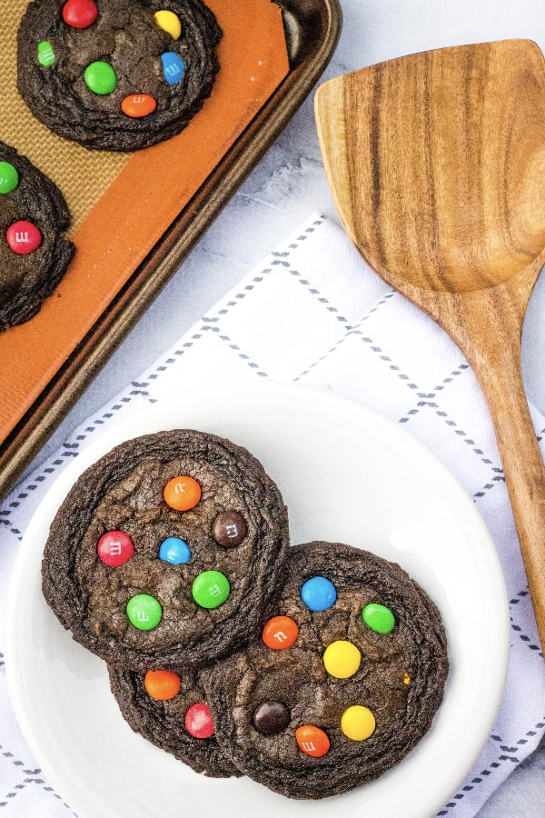 delicious brownie mix cookies with M&Ms in them, on a white plate