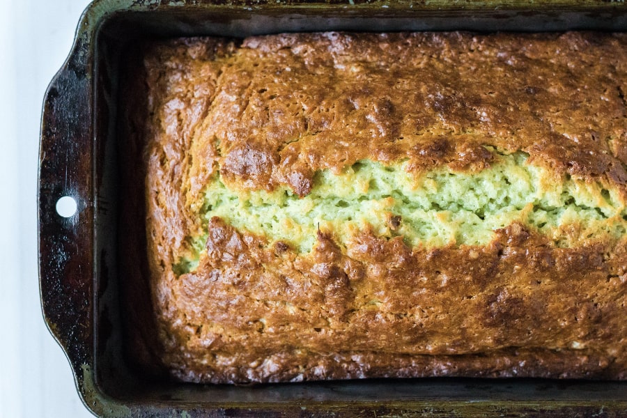 top of a loaf of banana pistachio bread in a pan