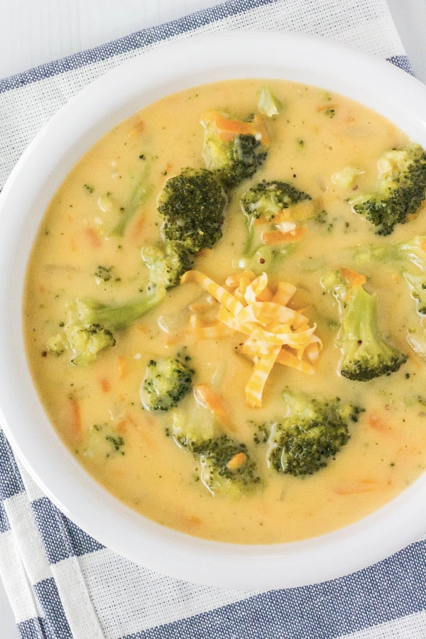 white bowl of chunky broccoli cheese soup made with frozen broccoli