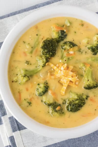 white bowl of broccoli cheese soup that was cooked in the Instant Pot pressure cooker