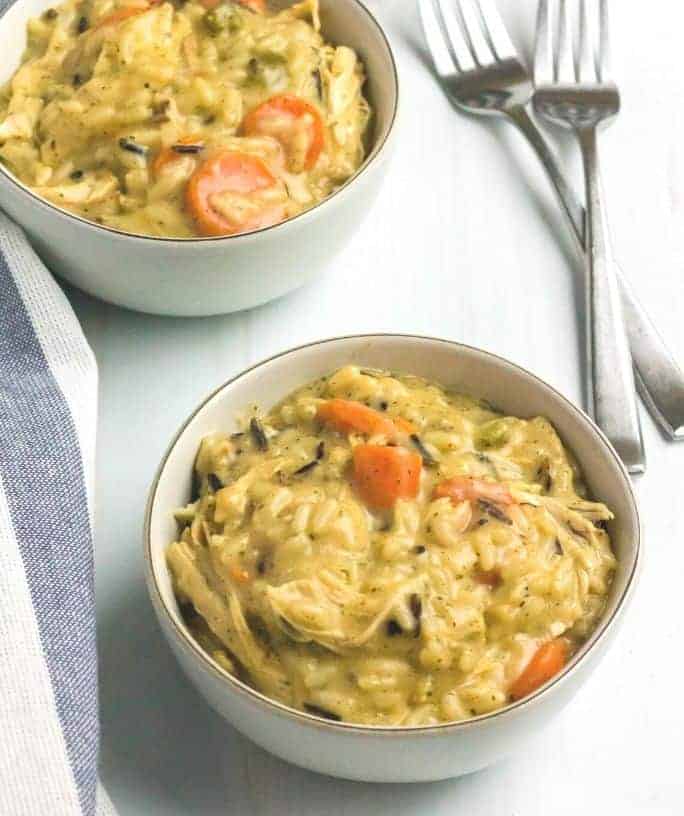 two white bowls of chicken and wild rice casserole cooked in the Instant Pot pressure cooker