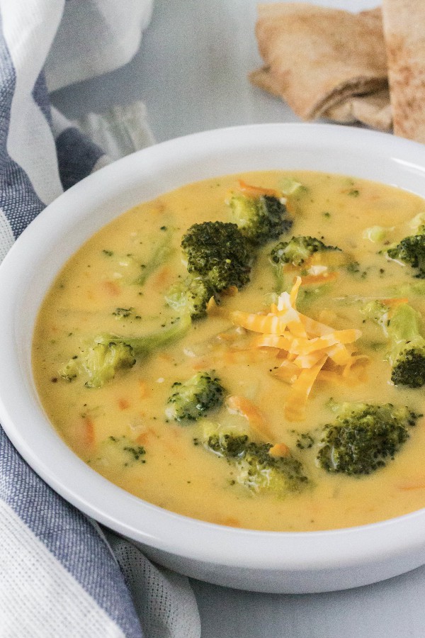 white bowl filled with broccoli cheese soup that was cooked in the pressure cooker