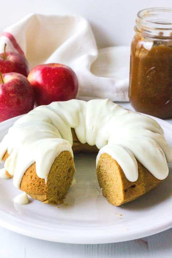 cream cheese glazed apple butter cake on a white plate