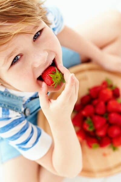 kid eating strawberries