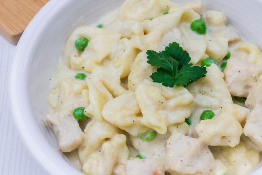 peas, chicken, and tortellini that were cooked in the Instant Pot, in an alfredo sauce