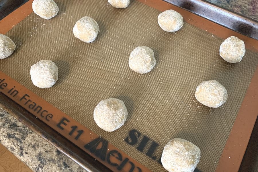 apple butter snickerdoodle dough rolled into balls on a baking sheet