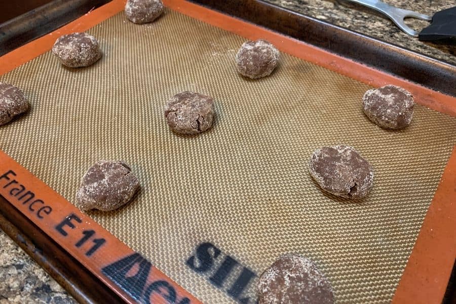 chocolate snickerdoodle dough balls on a baking sheet