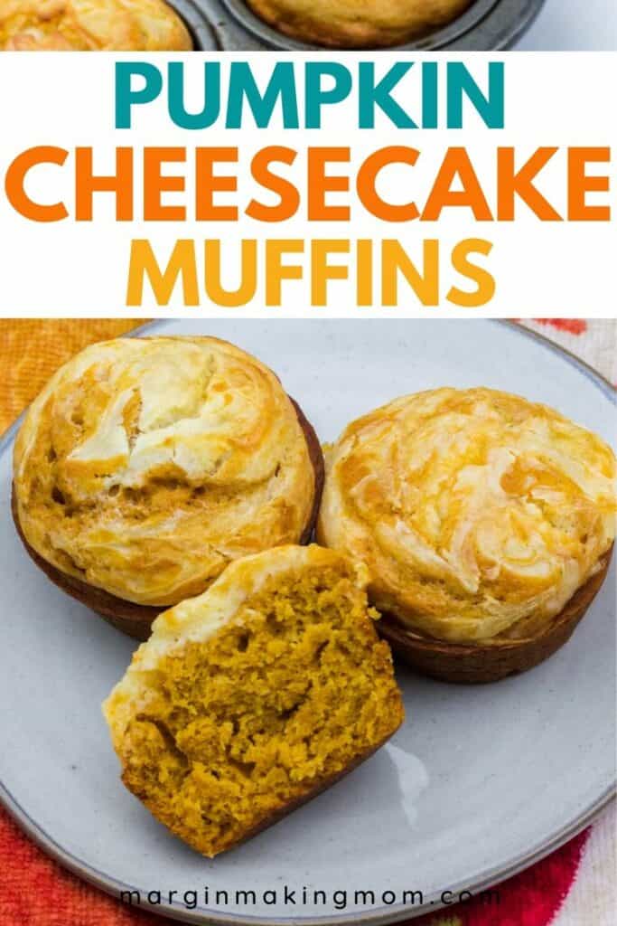 pumpkin cheesecake muffins on a gray plate, with one muffin cut in half