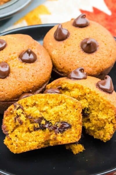 plate full of pumpkin muffins with chocolate chips
