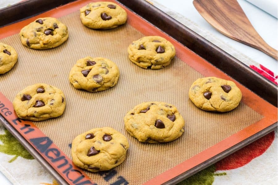 baking sheet with freshly baked pumpkin chocolate chip cookies on it