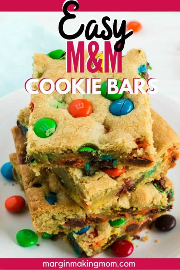 stack of M&M cookie bars on a white plate