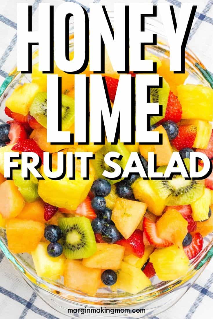 bowl of fruit salad tossed with honey lime dressing