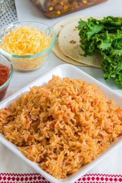 plate of Instant Pot Spanish rice next to other ingredients for a Mexican dinner