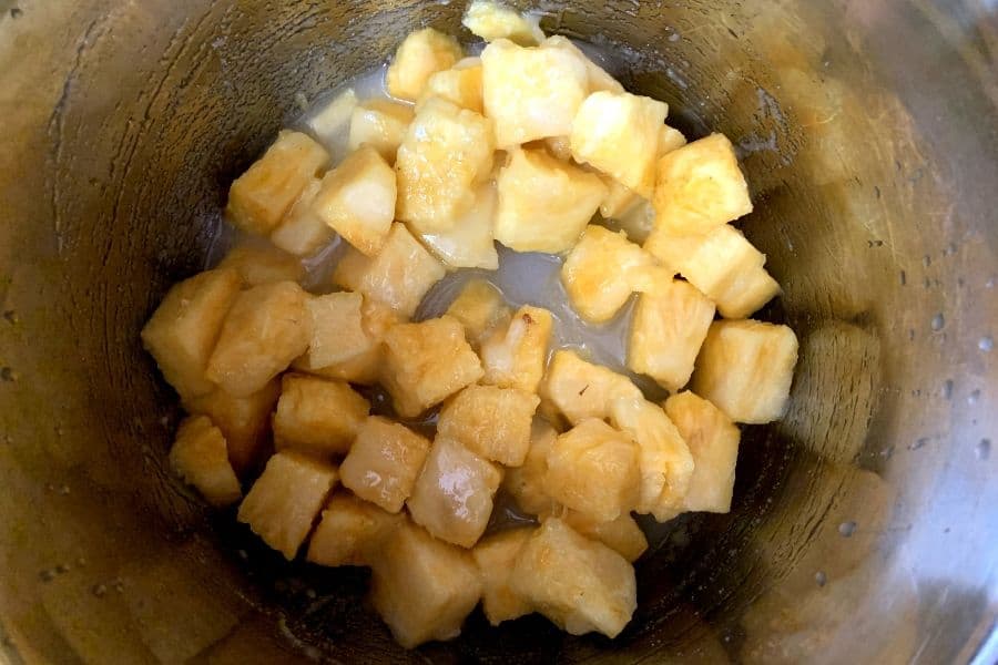 pineapple, sugar, and lemon juice mixed in the insert pot of the Instant Pot