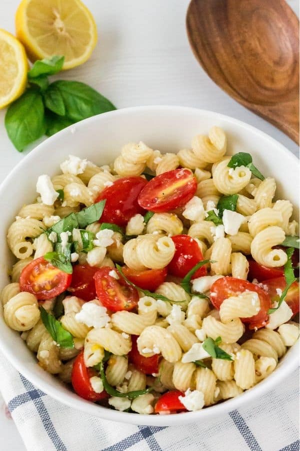 Serving bowl filled with lemon basil tomato pasta salad