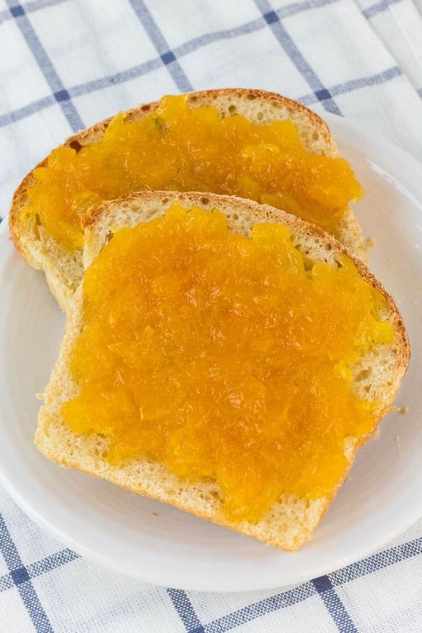 pineapple jam spread onto two pieces of sourdough bread