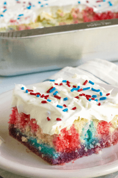 slice of patriotic poke cake on a white plate