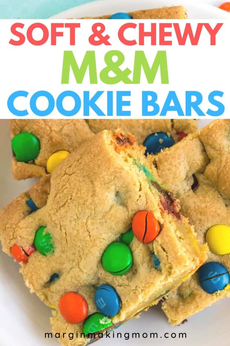 a few M&M cookie bars on a white plate