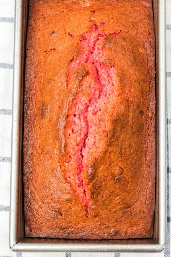 a full loaf of strawberry banana bread in a loaf pan
